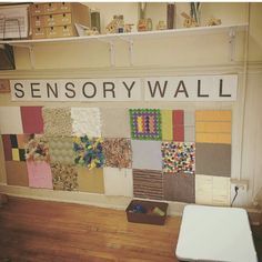 there is a wall that has many different items on it and the words sensory wall above it