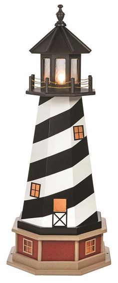 a lighthouse with a light on top of it's roof and lights in the windows