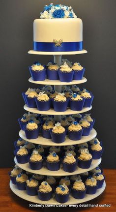 a three tiered cake with cupcakes on the bottom and blue frosting