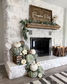 a fireplace decorated with white pumpkins and greenery next to a sign that says pumpkin patch