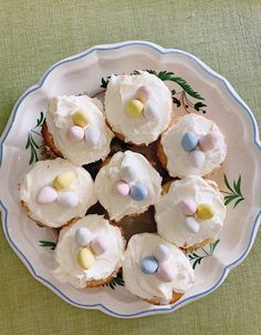 a white plate topped with cupcakes covered in frosting