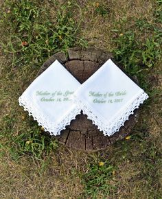 two wedding handkerchiefs on top of a tree stump