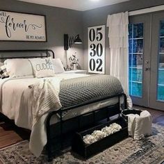 a bedroom with gray walls and white furniture