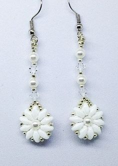 These earrings are so pretty and delicate. Double hole beads are hand beaded into a flower shape with a center pearl or crystal. Finished with sweet bicone crystals and silver plated earwires. Your choice of: white/blue pearl white/white pearl silver/silver crystal silver/white pearlEarrings are approx. 2.25" long from earwire to tip of flower and 5/8" wide from center of flower. Snow Flower, Silver Flower Earrings, White Pearl Earring, Pearl Flower, Blue Pearl, Floral Jewellery, Silver Drop Earrings, Silver Flowers, Silver Pearls