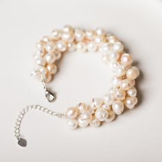 "* CULTURED FRESHWATER PEARL - Pearls are the only jewels created by a living animal. For this bracelet, the color of the pearls are creamy white and light pink. Every pearl is unique. In Western cultures, the pearl has astrological associations with the planet Venus. Like pearls, the goddess of love came from the sea. * ADJUSTABLE LENGTH - This bracelet adjustable length 7 - 9.5 inches (2.5\" extension chain), lobster claw clasps. * BRACELET DESIGN - This cultured freshwater pearl bracelet get Cream Pearl Bracelet Gift, Cream-colored Round Pearl Bracelet, Gift Cream Pearl Bracelet, Adjustable Cream Pearl Bracelet, Adjustable Pearl Bracelets, Adjustable Cream Pearl Bracelets, Cluster Bracelets, Pearl Cluster, Freshwater Pearl Bracelet