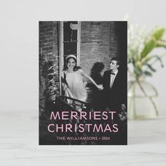 a christmas card with an image of a man and woman