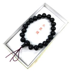 Black Kokutan Ebony Wood Japanese Juzu Bracelet Material : Kokutan (Ebony) Wood, Silk elastic cord Wrist size : 6.7in (about 17cm) We adjust the size to your wrist for fee. Head bead : about 12mm Main beads : about 8mm / 10mm Two Small beads : about 7mm / 8mm Handmade in Kyoto, JAPAN Ebony is a dense black / brown hardwood, most commonly yielded by several different species in the genus Diospyros, which also contains the persimmons. Ebony is dense enough to sink in water. It is finely-textured and has a very smooth finish when polished, making it valuable as an ornamental wood. It's very fit for as a gift or souvenir. In Japan, Buddhists have Prayer beads (Juzu, Nenju). Kyoto is famous as a producing center of Prayer beads. Maintenance Take off when you shower and before going to bed. The Traditional Black Beaded Bracelets For Meditation, Spiritual Black Hand-strung Wristband, Traditional Black Bracelet Gift, Traditional Black Bracelet As Gift, Traditional Black Bracelet For Gift, Traditional Black Beaded Bracelets As Gift, Traditional Black Wristband As A Gift, Traditional Handmade Black Wristband, Traditional Black Adjustable Wristband