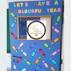 a colorful door decorated with crayons and the words let's have a colorful year