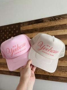 "Light pink or tan snap back high crown foam trucker hat detailed with coral pink \"In a Yeehaw State of Mind\" graphic." Bach Trucker Hats, Trucker Hat Vinyl, Pink Flat Brim Trucker Hat, Pink Trucker Snapback Hat With Flat Brim, Pink Adjustable Trucker Mini Hats, Pink Trucker Baseball Cap With Flat Brim, Pink Trucker Cap With Flat Brim, Pink Adjustable Trucker Hat With Flat Brim, Pink Adjustable Trucker Hat