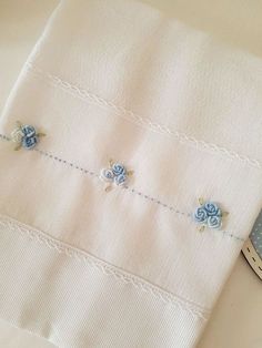 a close up of a cloth with flowers on it and a cell phone next to it