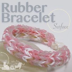 two pink and white braided bracelets sitting on top of each other