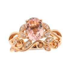 a ring with an oval morganite surrounded by white and brown diamonds on the band