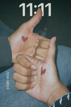 two hands with hearts painted on them making the shape of a heart and number 11 11 11