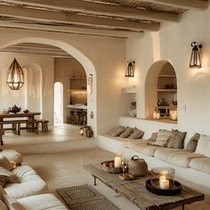 Mediterranean living room with abundant natural light pendant lights chandeliers table lamps and candles Mediterranean House Interior, English Cottage Kitchens, Mediterranean Home Interior, Mediterranean Interior Design, Wall Nails, Living Room Decor Wall