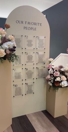 a display with flowers on it in front of a sign that says our favorite people