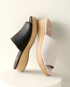 A casual slide in rich leather with a slight wedge, for an everyday slip-on that's a touch above the rest. Well crafted with comfy padding and a sustainable-wood base.  By EILEEN FISHER. Leather-wrapped padded footbed. Wood wedge and platform. Man-made sole. Modern Spring Clogs With Cushioned Footbed, Everyday Spring Slides With Arch Support, Modern Slides With Removable Insole For Everyday, Modern Leather Footbed Slides With Wedge Heel, Spring Everyday Clogs With Cushioned Footbed, Modern Wedge Heel Slides With Cushioned Footbed, Modern Slides With Leather Footbed And Wedge Heel, Spring Clogs With Cushioned Footbed For Everyday, Modern Cushioned Wedge Heel Slides