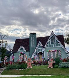 a house decorated for christmas with gingerbreads and candy canes on the lawn