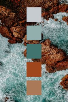 an aerial view of the ocean with rocks and water