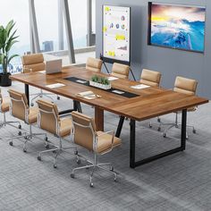 a conference table in an office setting with chairs around it and a television on the wall