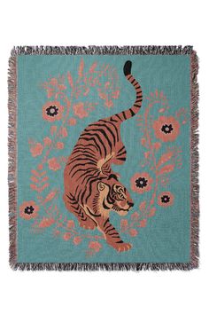 a blue and orange rug with a tiger on it's back, surrounded by flowers