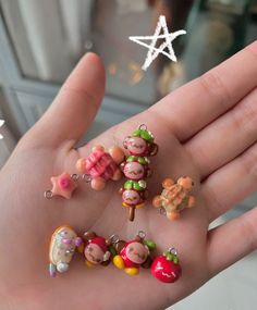 a person's hand holding several small figurines