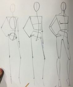 a drawing of three female mannequins in different positions, with one holding a pencil