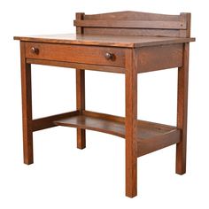 a wooden desk with two drawers and one shelf