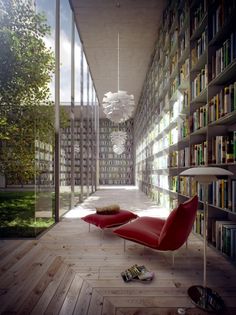 an empty room with bookshelves and a red chair