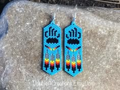 the beaded earrings are designed to look like native american indians