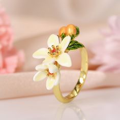 Enamel Jewelry For Spring Gifts, Spring Enamel Jewelry For Gifts, Spring Enamel Jewelry As Gift, Spring Gift Enamel Jewelry, Gold Enamel Flower Ring For Anniversary, Floral Enamel Wedding Jewelry, Yellow Gold Enamel Flower Ring Gift, Elegant White Enamel Ring For Gift, Anniversary Flower Ring In Enamel