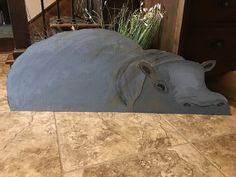 a hippopotamus planter sitting on the floor