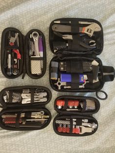 an assortment of tools are organized in a black zippered case on a white sheet