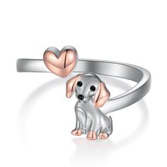 a silver dog ring with two hearts on it