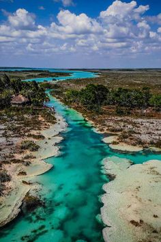 an aerial view of a river running through the middle of a desert area with blue water