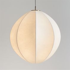 a white and beige light hanging from a ceiling fixture with two circles on each side