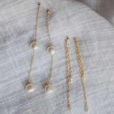 The enchanting Sirena earrings.. Button pearls strung on our dainty cable chain. These will make the perfect accessory for your after beach dinner or summer weddings. Make it a pair with the Sirena Necklace. - Made with 14k gold filled material - 6-7mm pearls - Ball stud with a 9mm post Please note: as pearls are naturally occurring, no two pearls will look the same. We'll try our best to pair pearls that match well together but your piece will have pearls that are uniquely and organically its own! Click here to view our shop policies, including our current processing times and more shipping information. Adjustable Dangle Pearl Earrings With Pearl Chain, Adjustable Dangle Pearl Chain Earrings, White Pearl Earrings With Adjustable Chain For Gift, Delicate White Earrings With Adjustable Chain, Gift White Pearl Earrings With Adjustable Chain, Adjustable Dangle Earrings With Pearl Chain, Adjustable Pearl Chain Earrings, Delicate 14k Gold Filled Earrings With Pearl Chain, Elegant Wedding Threader Earrings