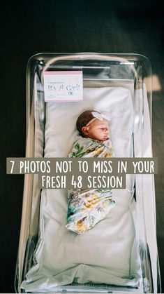 a baby wrapped in a blanket is laying in a clear box