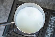 a pan filled with liquid sitting on top of a stove