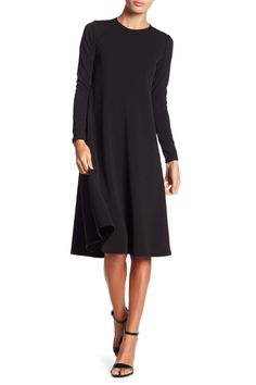 This long sleeve A-line dress is great for the office or dinner and makes for a classy, put-together look. Fit: this style runs small. 43" length (size Small) Crewneck
 Long sleeves A-line skirt 47% polyester, 47% rayon, 6% spandex Machine wash Made in the USA Model stats: 5'10", 32" bust, 25" waist, 36" hip. Model is wearing size Small. Fall Long Sleeve Midi Dress With Flattering Silhouette, Fall Long Sleeve Dresses With Flattering Silhouette, Fall Midi Dress With Flattering Silhouette And Long Sleeves, Fall A-line Midi Dress With Flattering Silhouette, Spring Midi Dress With Flattering Silhouette And Long Sleeves, Sleek A-line Dresses For Fall, Solid Color A-line Long Sleeve Dress For Fall, Formal Sleek Long Sleeve Fall Dress, Long Sleeve Dress With Flattering Silhouette