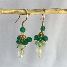 Cluster earrings with faceted oval Prehnite, natural Chrysoprase spheres, faceted green Agate spheres. Open hook. All components are in gold-plated 925 silver. Artisanal creation, made by hand. Earrings length: 4 cm (1.57 inch) Prehnite: 7.5/6 mm. Chrysoprase: 3.5/4 mm. Green agate: 4 mm. After checking and cleaning, they will be packaged in a nice gift box. Unique piece ready for delivery. Hand Earrings, 925 Silver Earrings, Green Agate, Cluster Earrings, Jewelry Earrings Dangle, Silver Earrings, 925 Silver, Dangle Drop Earrings, Agate