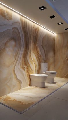 a bathroom with marble walls and flooring next to a toilet in a room that has lights on the ceiling