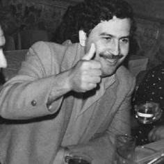 black and white photograph of two men sitting at a table with drinks in front of them