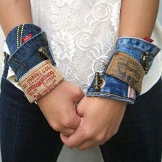 two people holding hands in jeans with tags on them