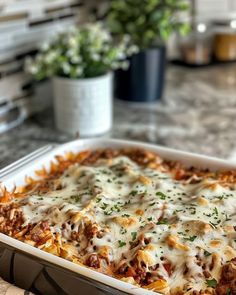 a casserole dish with cheese and meat in it sitting on a counter top