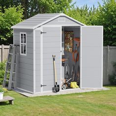 a gray shed with tools in it