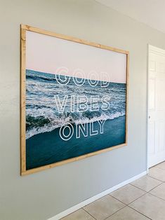 a painting hanging on the wall in a room with tile flooring and white walls