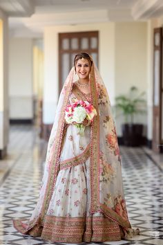 a woman in a bridal gown holding a bouquet