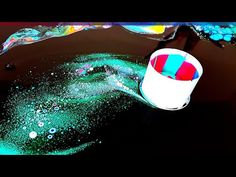 an image of a bucket with paint on it in the middle of water and bubbles