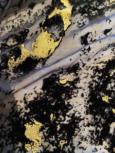 black and yellow paint splattered on the ground