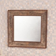 a bathroom mirror mounted to the side of a wall